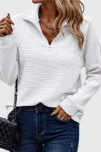 Women's ribbed quarter-zip sweater with long sleeves and raised collar