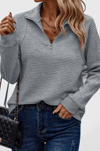 Women's ribbed quarter-zip sweater with long sleeves and raised collar