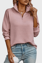 Women's ribbed quarter-zip sweater with long sleeves and raised collar