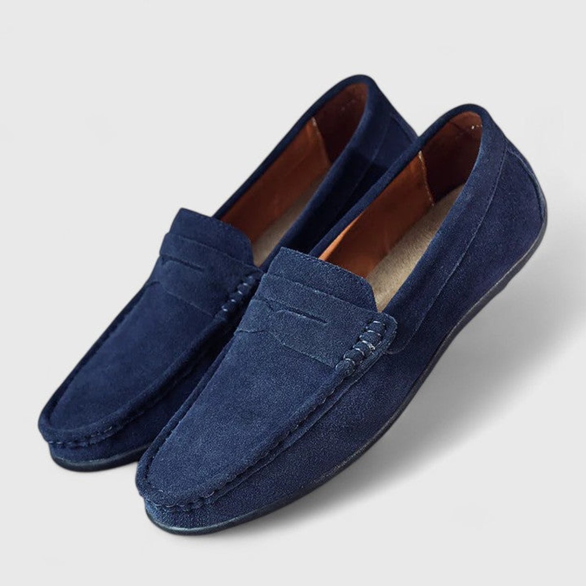 Men's blue penny loafers with moc toe stitching