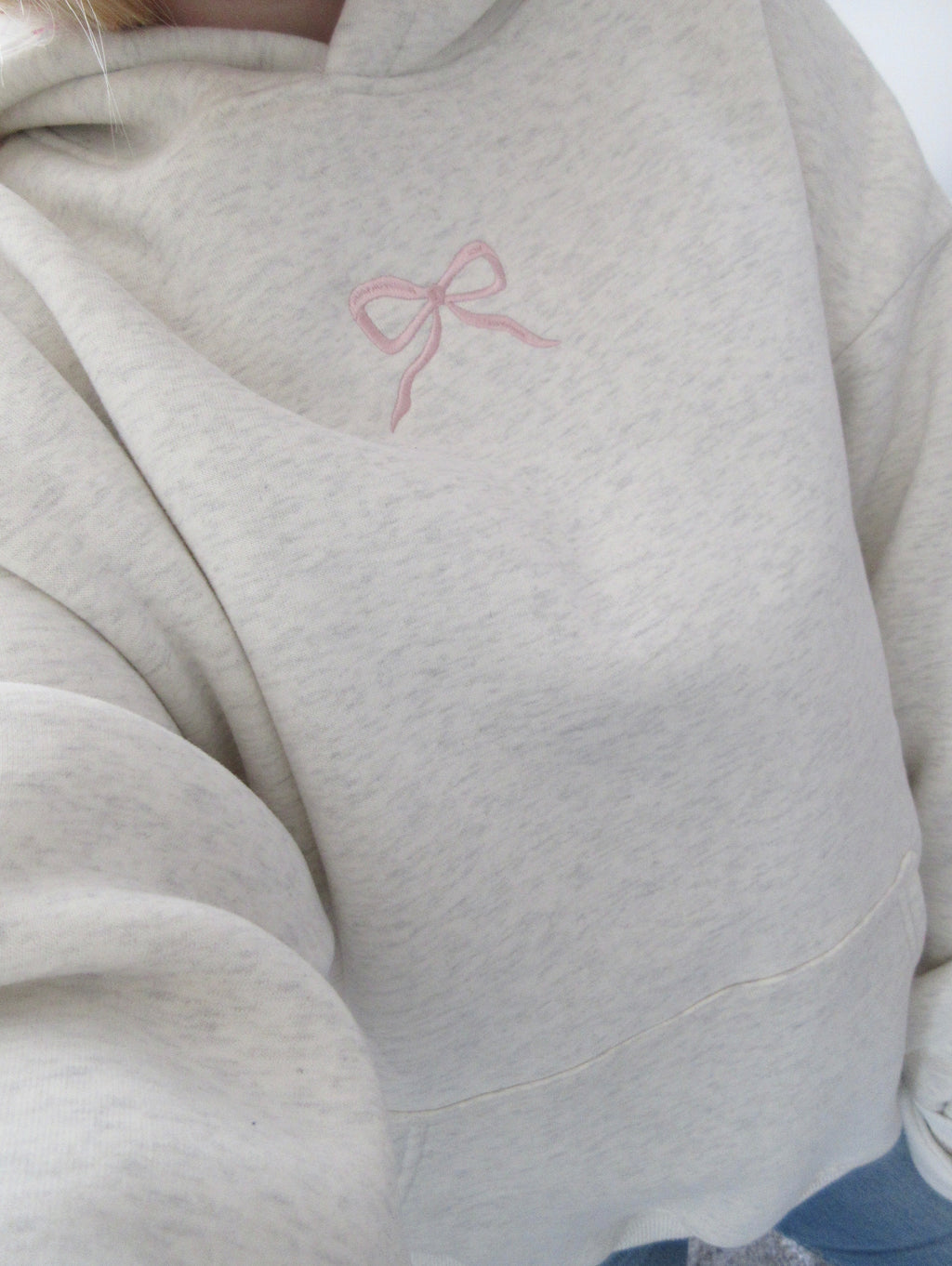 Women's light grey oversized hoodie with pink bow embroidery and floral-lined hood