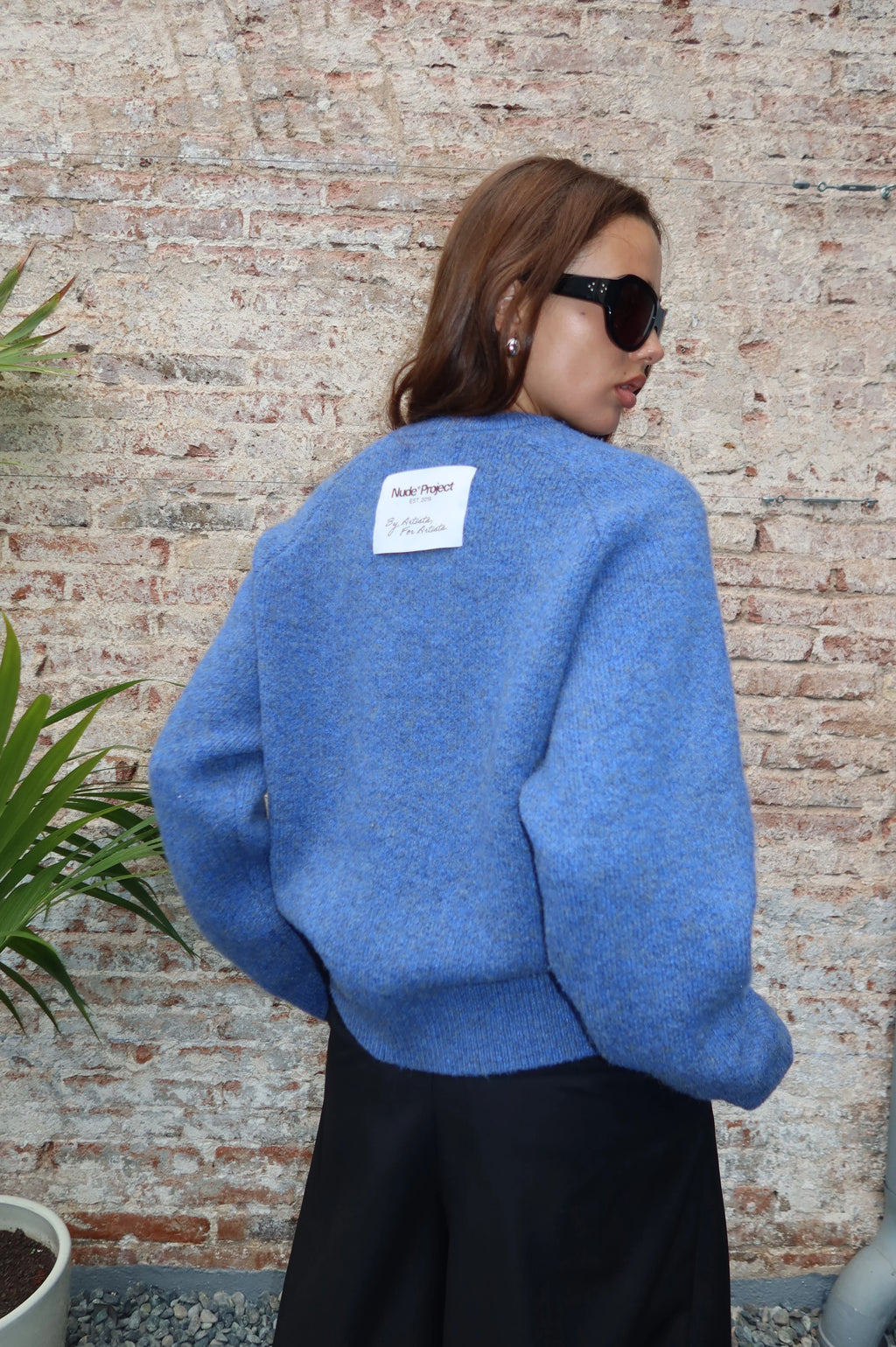 Women's blue crew-neck knit sweater with chest emblem