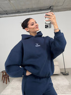 Blue women's hoodie with hood, long sleeves and chest logo