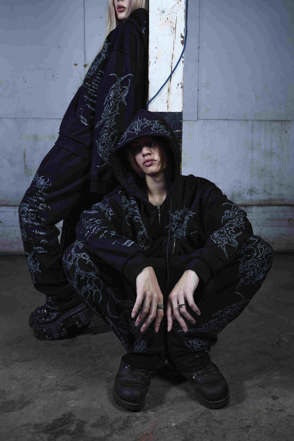 Black graphic zip hoodie with drawstring hood and long sleeves