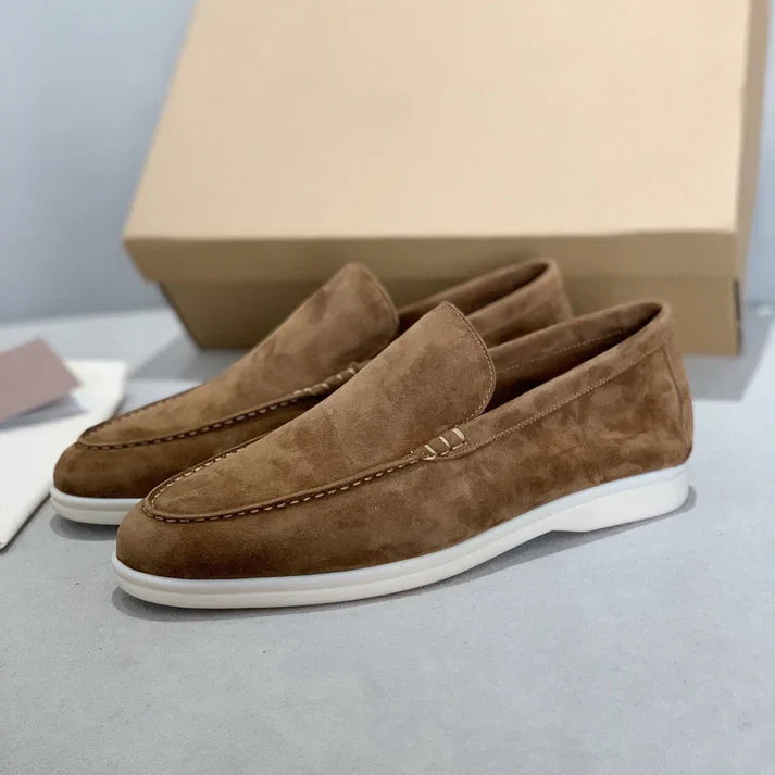 Men's slip-on loafers with textured uppers, moc toe stitching and white flat soles