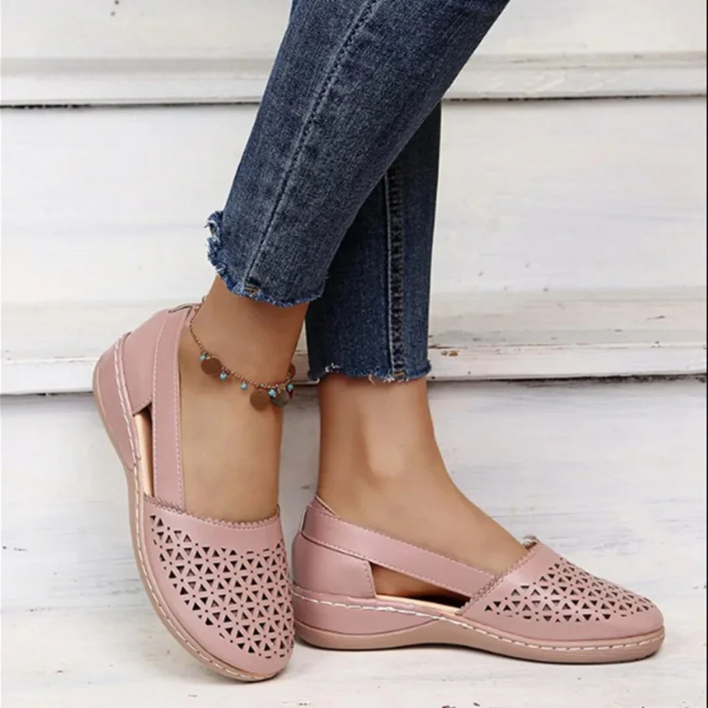 Women's perforated Mary Jane flats with triangular cutouts and an instep strap