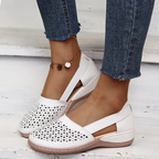 Women's perforated Mary Jane flats with triangular cutouts and an instep strap