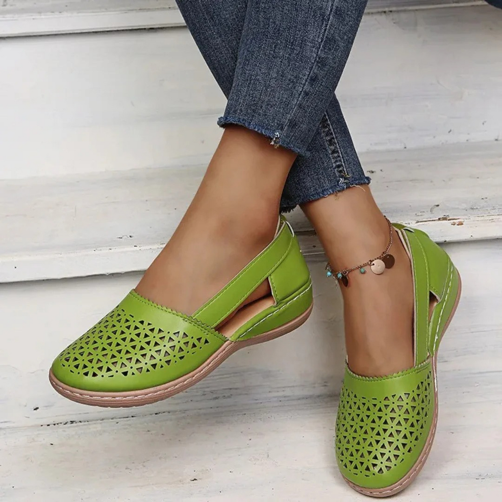 Women's perforated Mary Jane flats with triangular cutouts and an instep strap