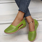 Women's perforated Mary Jane flats with triangular cutouts and an instep strap