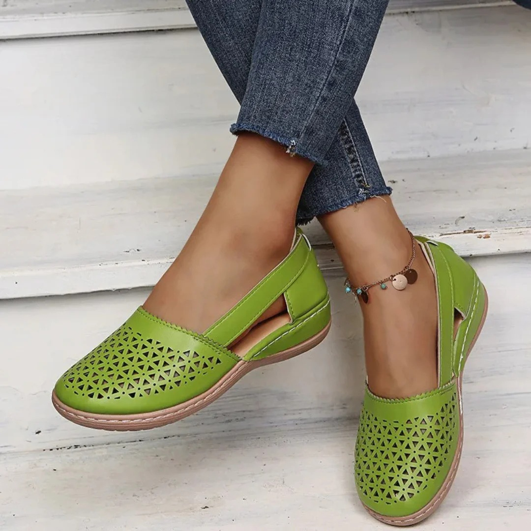 Women's perforated Mary Jane flats with triangular cutouts and an instep strap
