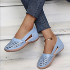 Women's perforated Mary Jane flats with triangular cutouts and an instep strap