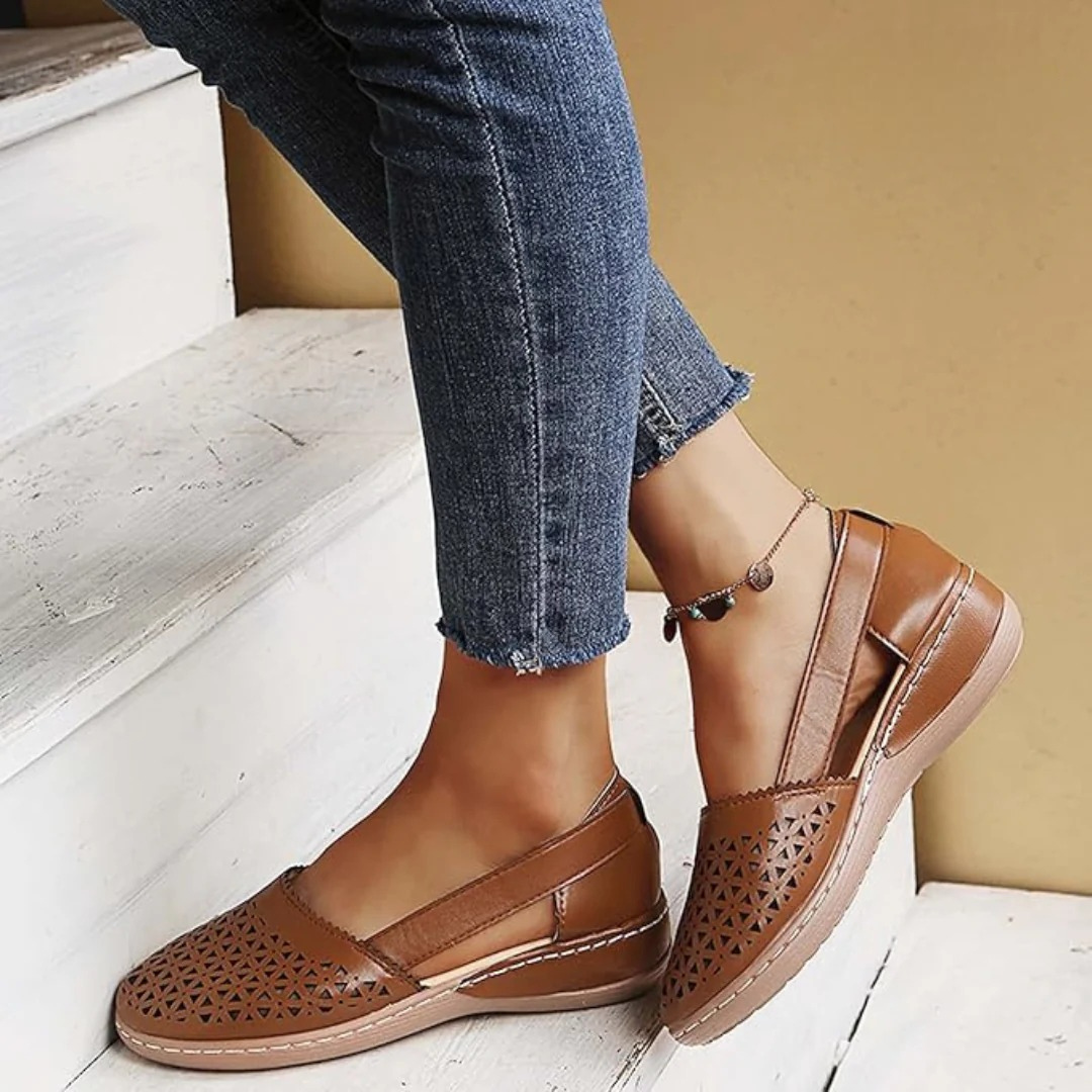 Women's perforated Mary Jane flats with triangular cutouts and an instep strap