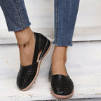 Women's perforated Mary Jane flats with triangular cutouts and an instep strap
