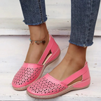 Women's perforated Mary Jane flats with triangular cutouts and an instep strap