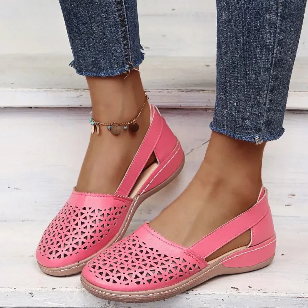 Women's perforated Mary Jane flats with triangular cutouts and an instep strap