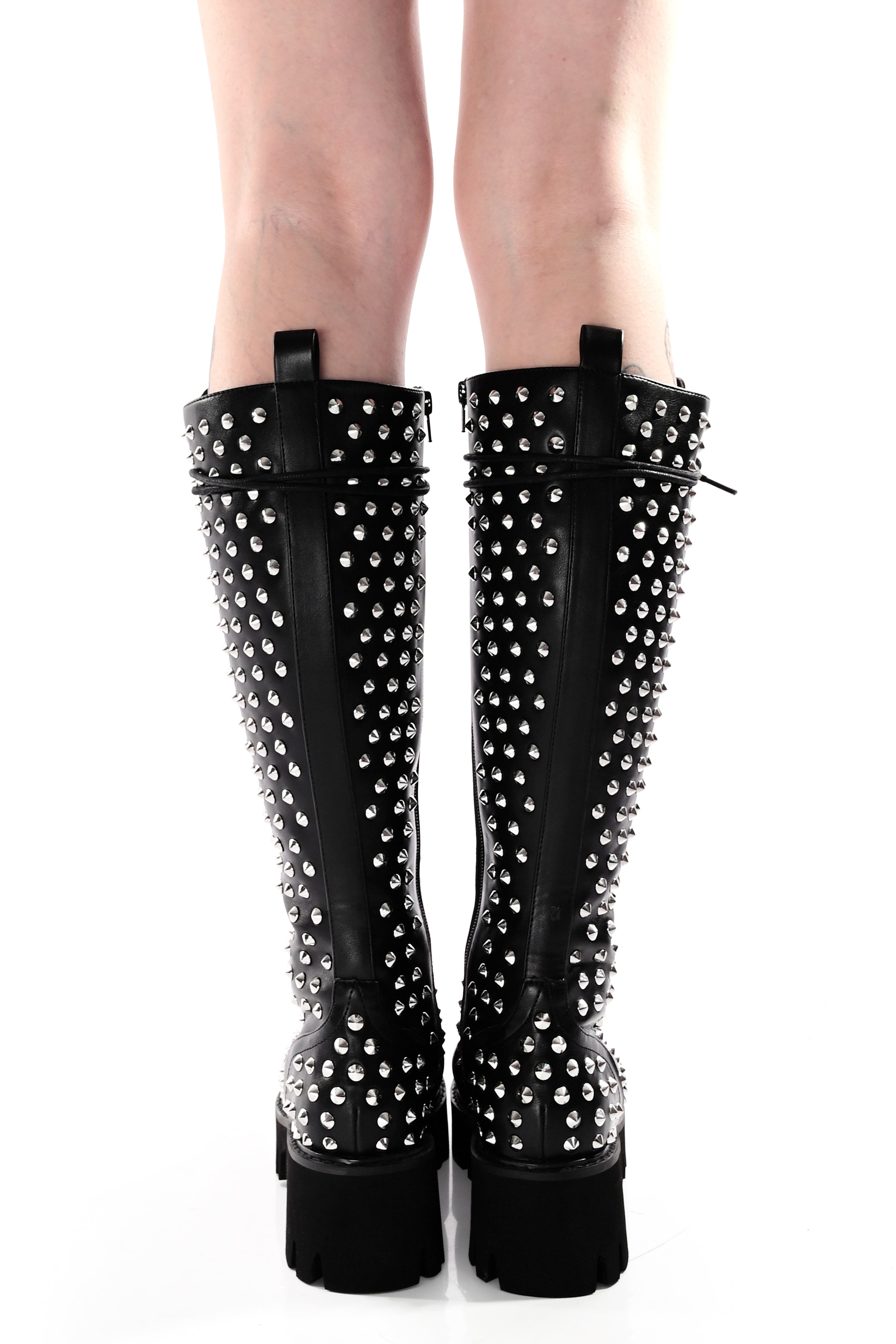 Women's black knee-high lace-up boots with silver studs and lugged soles