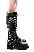 Women's black knee-high lace-up boots with silver studs and lugged soles