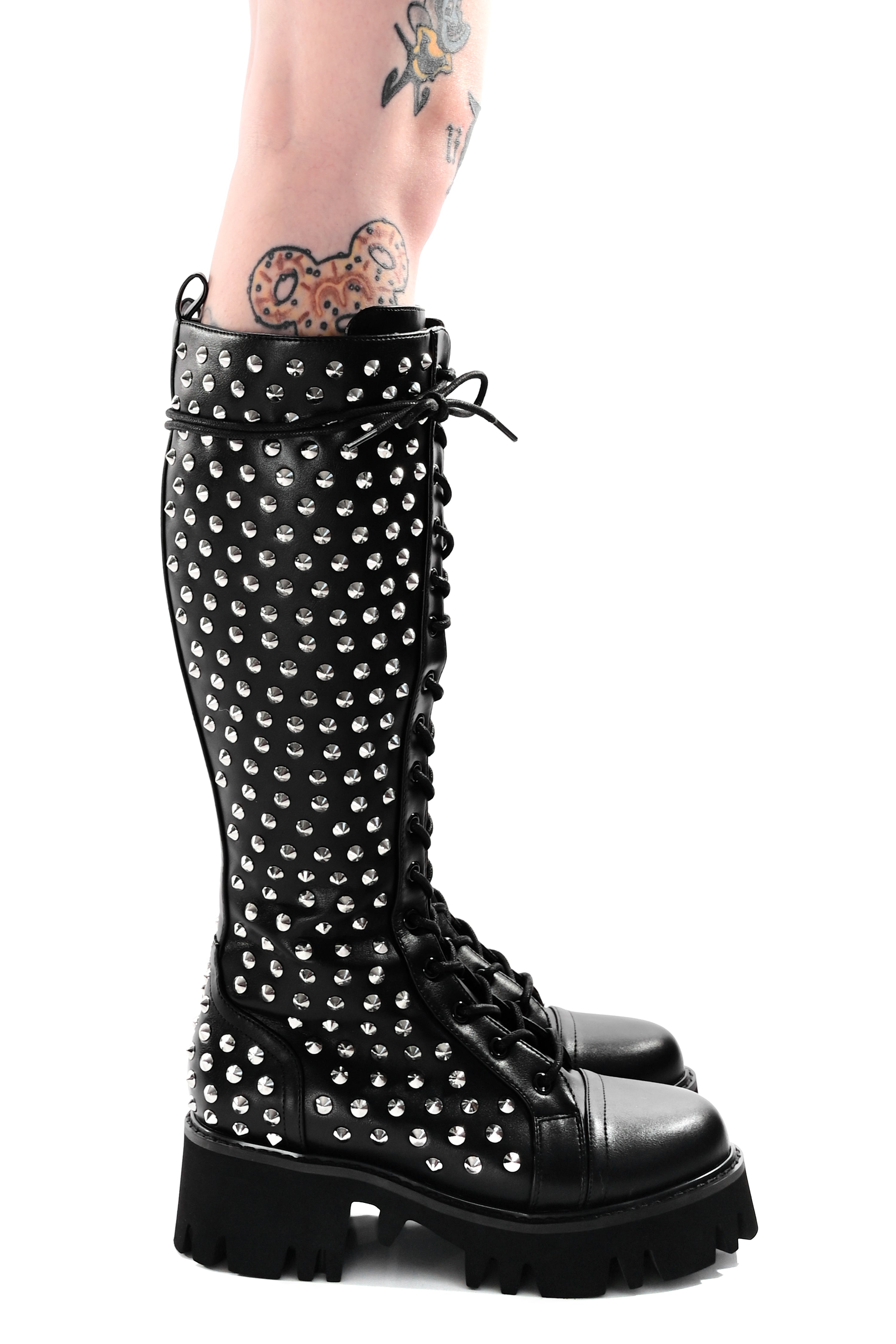 Women's black knee-high lace-up boots with silver studs and lugged soles