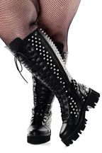 Women's black knee-high lace-up boots with silver studs and lugged soles