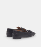 Women's black slip-on loafers with tassel detailing and flat heels
