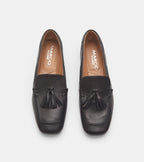 Women's black slip-on loafers with tassel detailing and flat heels
