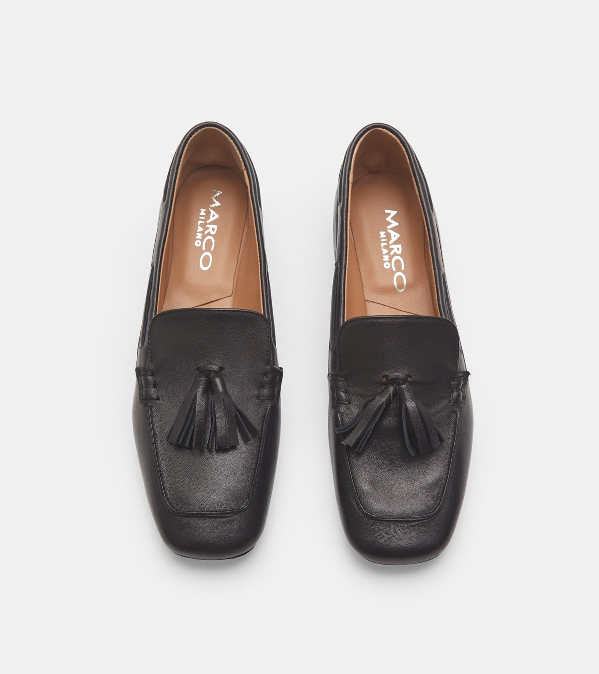 Women's black slip-on loafers with tassel detailing and flat heels