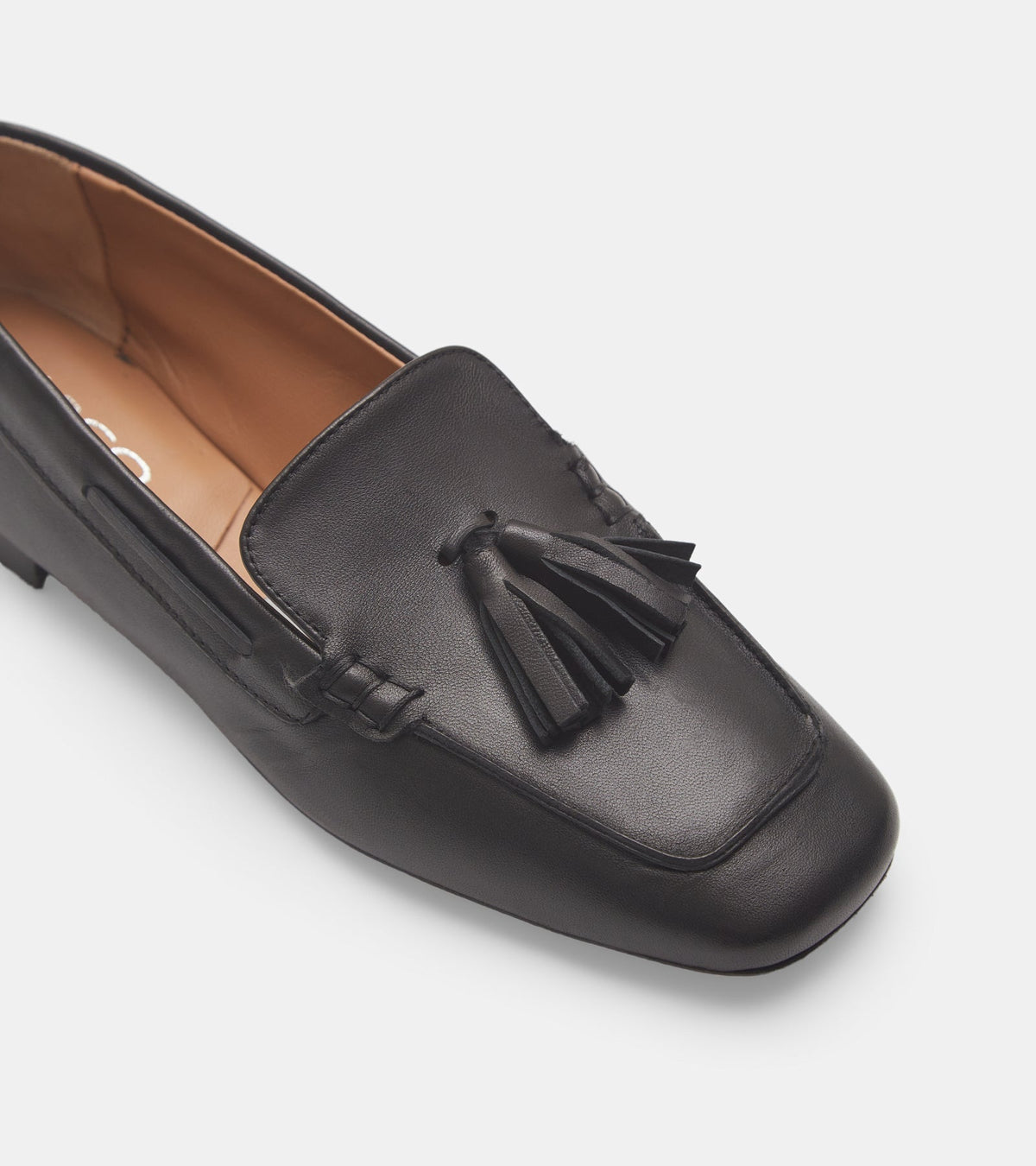 Women's black slip-on loafers with tassel detailing and flat heels