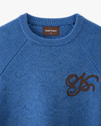 Women's blue crew-neck knit sweater with chest emblem