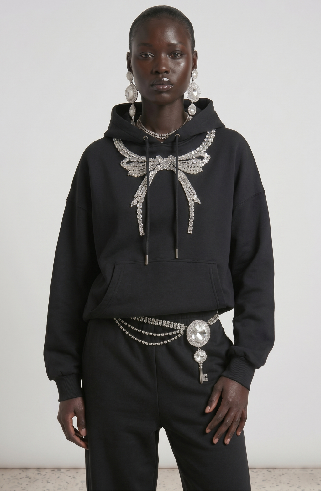 Black embellished hoodie with drawstring hood and wing motif
