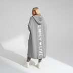 Woman wearing a longline hooded cardigan with vertical text and heart detail