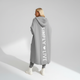 Woman wearing a longline hooded cardigan with vertical text and heart detail