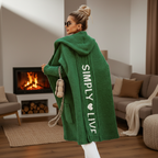 Woman wearing a longline hooded cardigan with vertical text and heart detail
