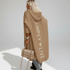 Woman wearing a longline hooded cardigan with vertical text and heart detail