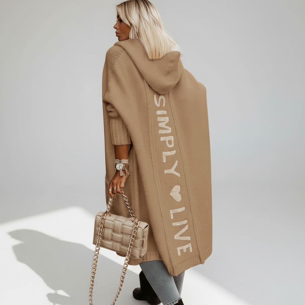 Woman wearing a longline hooded cardigan with vertical text and heart detail