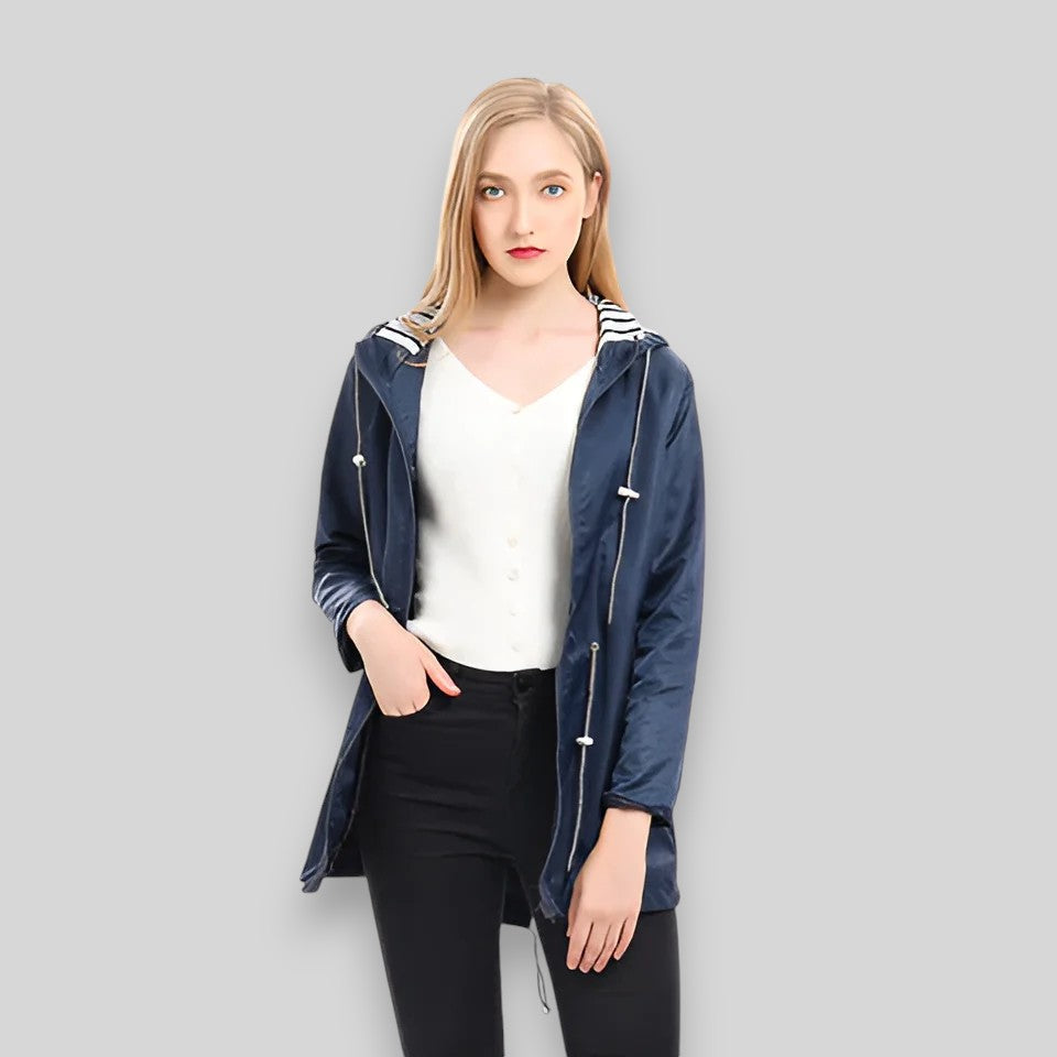 Women's hooded longline rain jacket with striped lining and zipped pockets