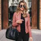 Woman wearing a fitted leather jacket with stand collar and zipper