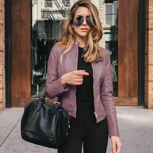 Woman wearing a fitted leather jacket with stand collar and zipper