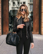 Woman wearing a fitted leather jacket with stand collar and zipper