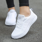 Women's low-top lace-up sneakers with textured knit-style uppers and flat soles