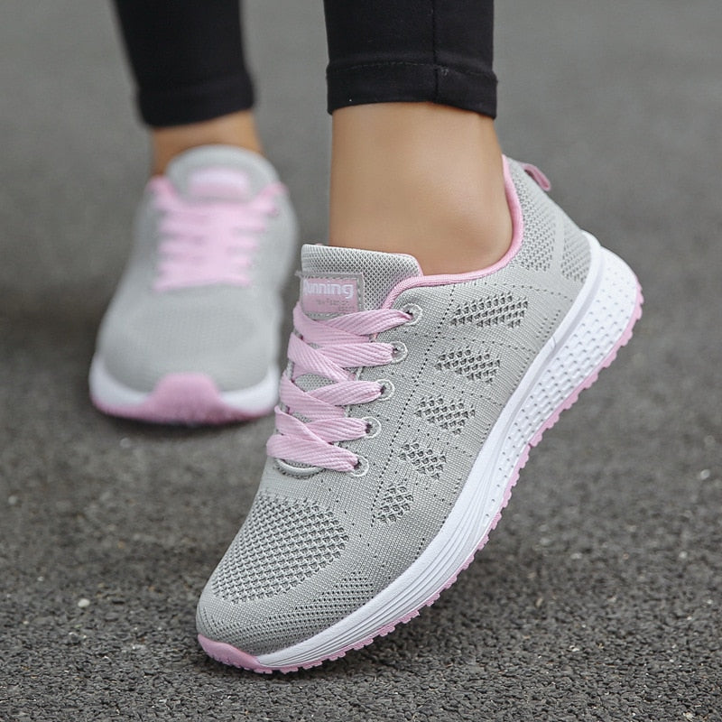 Women's low-top lace-up sneakers with textured knit-style uppers and flat soles