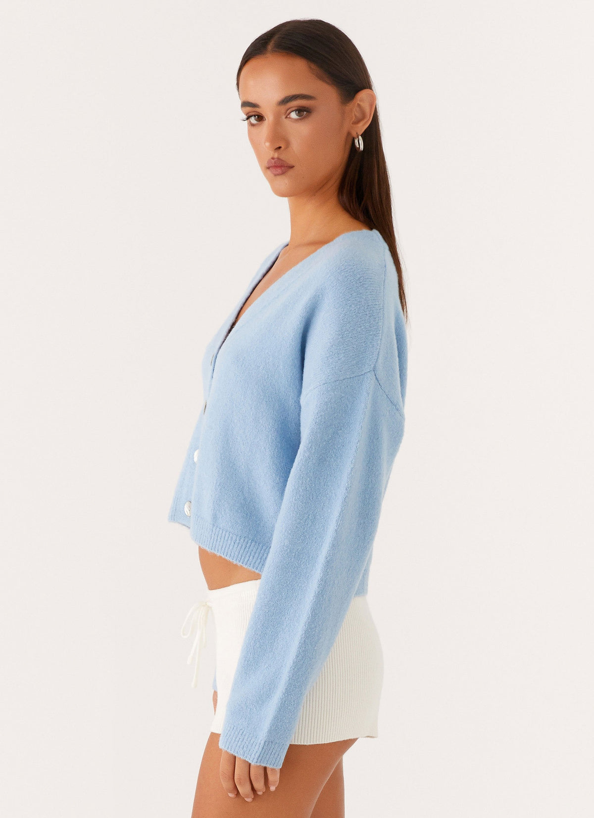 Women's blue cropped V-neck cardigan with long sleeves and button front