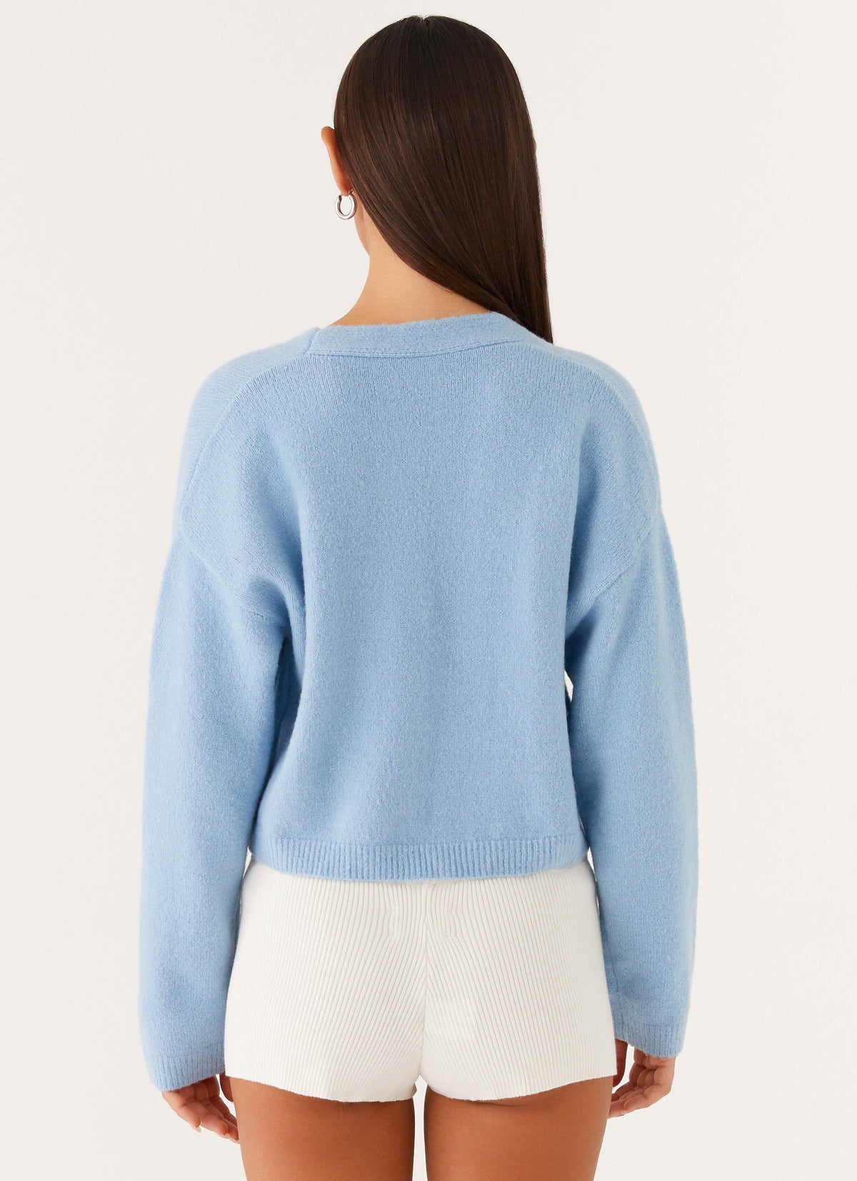 Women's blue cropped V-neck cardigan with long sleeves and button front