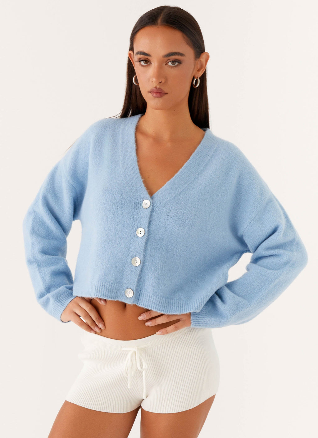 Women's blue cropped V-neck cardigan with long sleeves and button front
