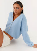 Women's blue cropped V-neck cardigan with long sleeves and button front