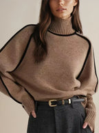 Women's oversized turtleneck sweater with contrasting trim and long sleeves