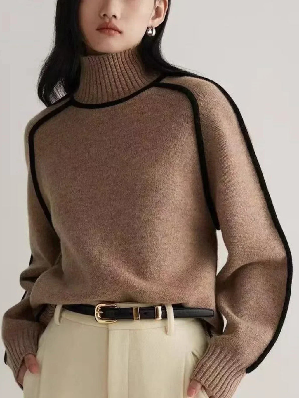 Women's oversized turtleneck sweater with contrasting trim and long sleeves
