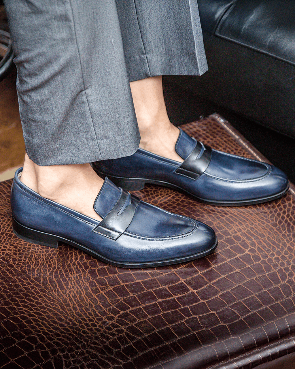 Blue penny loafers with square toes and low stacked heels