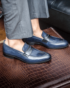 Blue penny loafers with square toes and low stacked heels