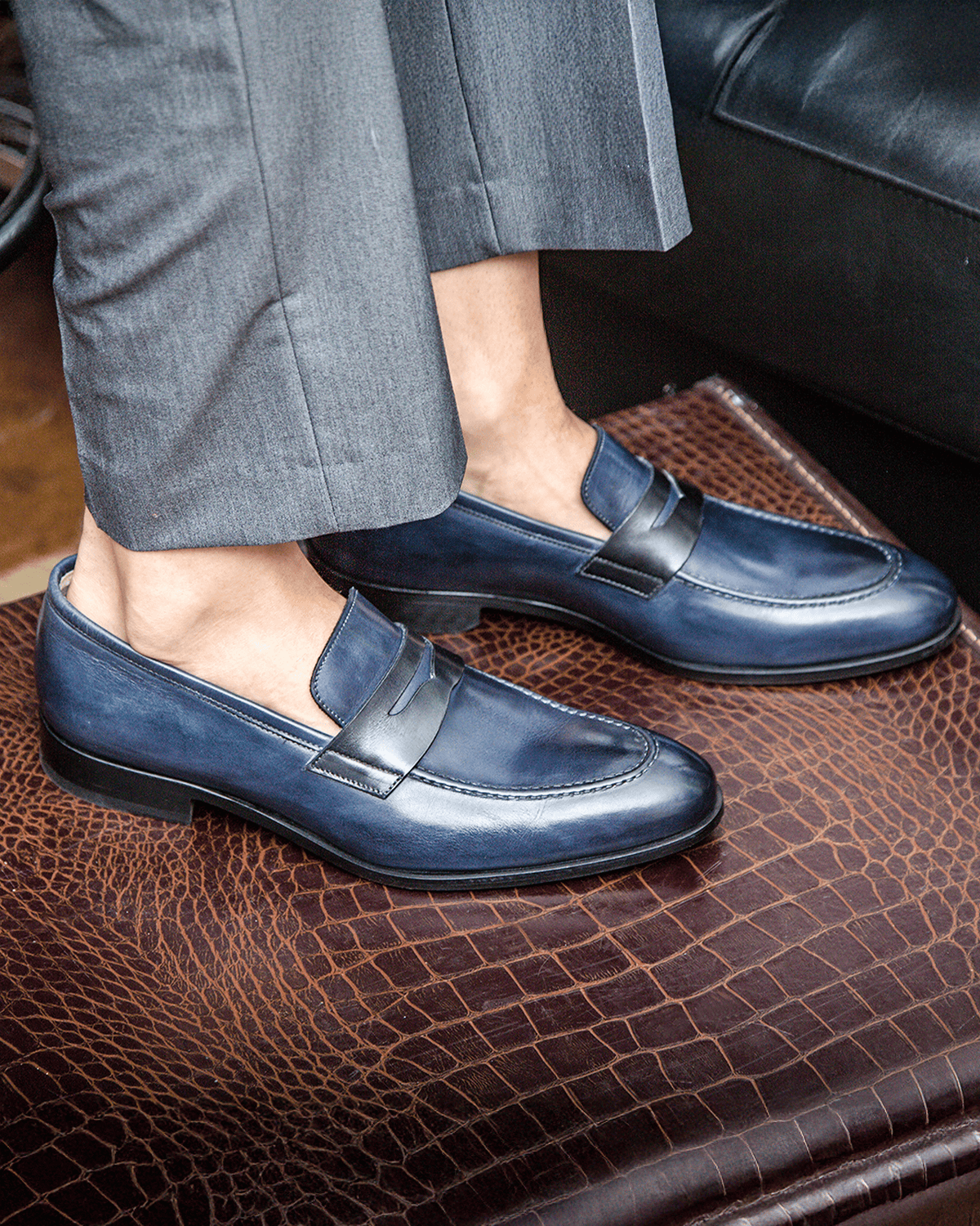 Blue penny loafers with square toes and low stacked heels