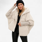 Women's oversized hooded quilted jacket with plush panels and ribbed cuffs
